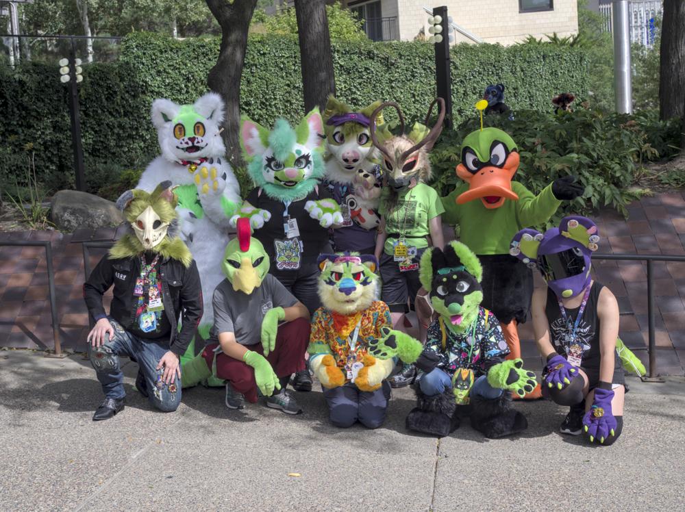 A group photo with 10 fursuiters who have all green as part of their suit's color palette